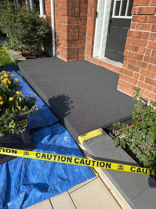 Front porch and step finished with a charcoal quartz coating, taped off while it cures